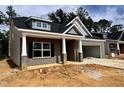 Attractive single-story home showcasing brick and gray siding, a two-car garage, and a welcoming front porch at 1085 Fairhaven Dr # 49, Mebane, NC 27302