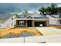New construction home featuring gray brick, a dormer window, and an attached two-car garage at 1085 Fairhaven Dr # 49, Mebane, NC 27302
