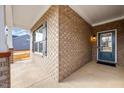 Inviting covered porch with brick accents, leading to a blue front door with a glass panel and sidelights at 1085 Fairhaven Dr # 49, Mebane, NC 27302