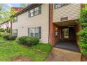 Townhouse exterior with brick accents, well-kept landscaping, and convenient access at 1217 Manassas Ct # H, Raleigh, NC 27615