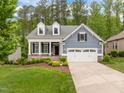 Beautiful two-story home with a well-maintained lawn, a two-car garage, and a welcoming front porch at 1620 Hasentree Villa Ln, Wake Forest, NC 27587