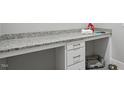 Functional laundry area with granite countertops, ample storage, and space for a pet bed, offering convenience at 1733 Birdhaven Ln, Wendell, NC 27591