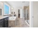 Bright bathroom featuring a soaking tub, tiled shower, double vanity, and walk-in closet at 2008 Campana Dr, Raleigh, NC 27603