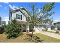 Beautiful two-story home with light blue exterior and a well-manicured lawn with mature trees at 2008 Campana Dr, Raleigh, NC 27603