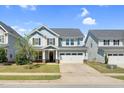 Charming two-story home with a two-car garage, beautiful stonework, and a well-manicured lawn at 2008 Campana Dr, Raleigh, NC 27603
