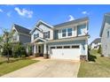 Attractive two-story home with a two-car garage, light blue siding, and well-kept front yard at 2008 Campana Dr, Raleigh, NC 27603