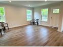 Bright living room features new flooring and plenty of natural light at 209 King St, Oxford, NC 27565