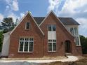 Two-story new brick home with white trim, dark roof and professional style at 2590 Silas Peak Ln, Apex, NC 27523
