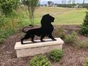 Community entrance featuring decorative lion statue and landscaped grounds at 2590 Silas Peak Ln, Apex, NC 27523