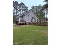 A view of the house from the backyard, showing the spacious deck at 282 W Thicket Dr, Angier, NC 27501
