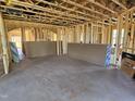 View of a framed living room under construction with exposed studs and materials at 3017 Dog Rose Dr # 169, Durham, NC 27703