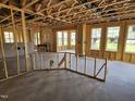 View of a living room under construction with exposed framing and windows at 3017 Dog Rose Dr # 169, Durham, NC 27703