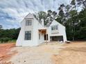 Two-story new construction home with a white painted brick exterior and attached two car garage at 3324 Founding Place, Raleigh, NC 27612