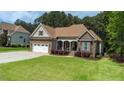 Charming stone and siding home with well-manicured lawn and attached two car garage at 3612 Griffice Mill Rd, Raleigh, NC 27610