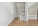 Bright entryway featuring wood floors, high ceilings, and a staircase with carpeted steps at 4418 Gallatree Ln, Raleigh, NC 27616
