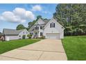 Lovely two-story home with an extended driveway and manicured lawn, perfect for a Gathering at 4418 Gallatree Ln, Raleigh, NC 27616