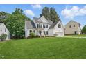 Well-maintained two-story home featuring a lush lawn, white siding, black shutters and an attached two-car garage at 4418 Gallatree Ln, Raleigh, NC 27616