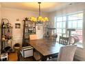 Bright dining room featuring a chandelier, large window, and wood table with seating for six at 501 Bellmeade Bay Dr, Durham, NC 27703