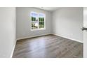 Bright bedroom with a large window offering a pleasant view at 517 Hidden Cellars Dr, Holly Springs, NC 27540