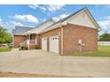 Brick house with a well-manicured lawn and a driveway leading to a two-car garage at 6042 Elliott Bridge Rd, Linden, NC 28356
