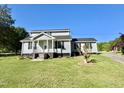 Charming two-story home with a well-manicured lawn, inviting front porch, and driveway at 668 Surl Mount Tirzah Rd, Timberlake, NC 27583
