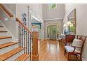 Grand foyer with hardwood floors, stairs, and elegant décor at 7400 Portpatrick Ct, Wake Forest, NC 27587
