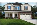 Charming two-story home featuring a brick facade, two-car garage, and freshly landscaped front yard at 741 Deschutes Dr, Garner, NC 27529