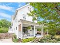 Beautiful two-story home featuring a covered front porch with seating area at 811 E Lane St, Raleigh, NC 27601
