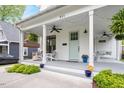 Inviting front porch with a swing, chairs, and tasteful decor at 811 E Lane St, Raleigh, NC 27601
