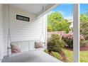 Relaxing front porch swing with decorative pillows and manicured landscaping at 811 E Lane St, Raleigh, NC 27601