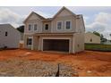 New construction home with attached garage and traditional design featuring gravel and dirt yard at 944 Bombardier Ln, Spring Hope, NC 27882