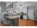 Bright kitchen with white cabinets, granite countertops, and stainless steel appliances at 1005 Stuart Dr, Mebane, NC 27302