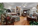 Cozy living room with hardwood floors, a brick fireplace, and comfortable seating at 1005 Stuart Dr, Mebane, NC 27302