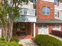 Inviting entrance showcasing brick accents, a charming balcony, and well-manicured landscaping at 10410 Rosegate Ct, Raleigh, NC 27617