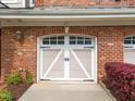 Close-up of the garage door featuring white trim and a decorative design, adding to the curb appeal at 10410 Rosegate Ct, Raleigh, NC 27617