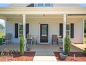 Charming front porch with seating area and landscaped accents at 109 E Fayetteville St, Micro, NC 27555