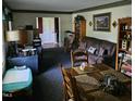 Cozy living room featuring comfortable seating, wooden furniture, and natural light at 1102 Parkwood Dr, Siler City, NC 27344