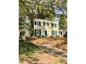 View of the home with mature trees, showing the yard and driveway at 112 Hilton Ave, Durham, NC 27707