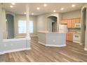 Open-concept living room and kitchen area featuring new floors and fresh paint at 113 Conner Dr # 203, Chapel Hill, NC 27514
