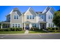 Street view of townhomes with well-maintained lawns and parking spaces at 124 Shale Creek Dr, Durham, NC 27703