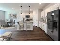 Modern kitchen with granite countertops, stainless steel appliances, and a stylish island at 15 Calluna Dr, Clayton, NC 27520