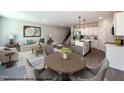 Open concept living room, dining area and kitchen featuring modern finishes and stainless appliances at 15 Calluna Dr, Clayton, NC 27520