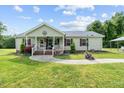 Charming single-story home featuring a covered front porch and well-manicured lawn at 1510 Asbury Church Rd, Sanford, NC 27330
