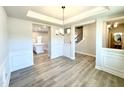 Elegant dining room features chair rail molding, a chandelier, and seamless access to kitchen and living areas at 1667 Pecan Drive # 25, Nashville, NC 27856
