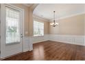 Dining area with modern lighting, chair rail, and large window at 1910 Morehead Hill Ct, Durham, NC 27703