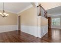 Open room with hardwood floors, crown molding, and stone fireplace at 1910 Morehead Hill Ct, Durham, NC 27703