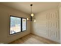 Stylish dining room with decorative wall trim, hardwood floors, and modern chandelier at 200 Broadleaf Ln, Louisburg, NC 27549