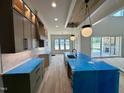 Open-concept kitchen featuring modern cabinetry, an island with seating, and a seamless flow to living spaces at 200 Broadleaf Ln, Louisburg, NC 27549