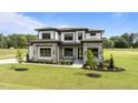 Beautiful two-story home with stone accents, manicured lawn, and professional landscaping at 200 Broadleaf Ln, Youngsville, NC 27596