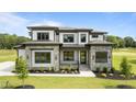Attractive two-story home with stone accents, manicured lawn, and professional landscaping at 200 Broadleaf Ln, Youngsville, NC 27596